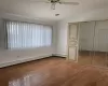 Unfurnished bedroom featuring a closet, lofted ceiling, wood-type flooring, and multiple windows