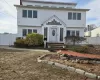 View of front of house with entry steps and fence