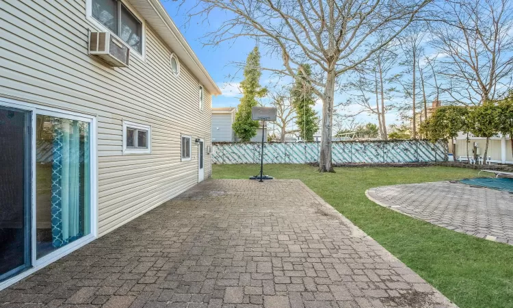 View of patio featuring fence