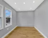 Spare room featuring a baseboard heating unit, light wood-style floors, and baseboards