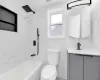 Bathroom featuring visible vents, toilet, bathtub / shower combination, vanity, and tile walls