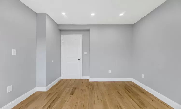 Unfurnished room with light wood-style flooring, baseboards, and recessed lighting