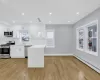 Kitchen featuring a baseboard heating unit, appliances with stainless steel finishes, modern cabinets, and white cabinets