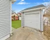 Detached garage with fence and concrete driveway