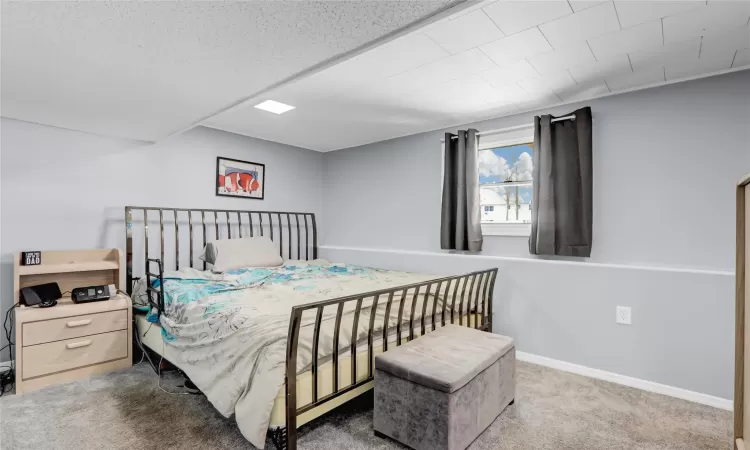 Bedroom featuring carpet flooring and baseboards