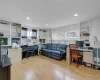 Home office with light wood-style flooring, built in features, and recessed lighting