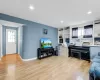 Living area featuring light wood-type flooring, baseboards, a wealth of natural light, and recessed lighting