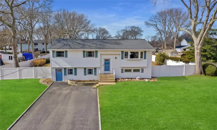 Split foyer home featuring fence private yard, driveway, and a front lawn