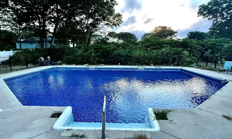 View of swimming pool featuring fence and a fenced in pool