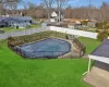 Community pool featuring a residential view, fence, and a yard