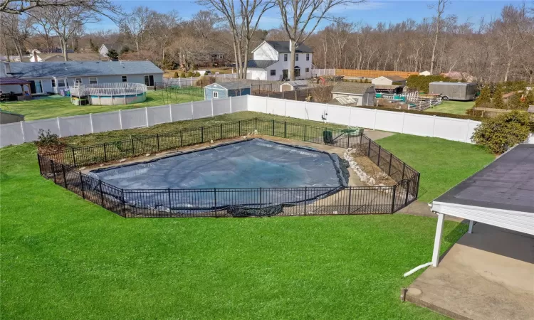 Community pool featuring a residential view, fence, and a yard