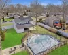 View of swimming pool with a residential view, a fenced backyard, and a yard