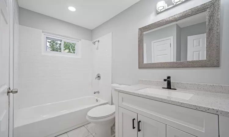 Bathroom with toilet, recessed lighting, vanity, and shower / bathtub combination