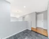 Spare room featuring attic access, baseboards, dark tile patterned floors, a notable chandelier, and recessed lighting