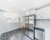 Kitchen featuring recessed lighting, stainless steel appliances, white cabinetry, baseboards, and light countertops