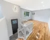 Foyer with recessed lighting, a notable chandelier, wood finished floors, baseboard heating, and a wall mounted AC