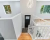 Staircase featuring a chandelier, baseboards, and wood finished floors