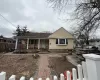 View of front of property featuring covered porch and fence