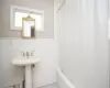 Bathroom featuring a wainscoted wall and a baseboard radiator