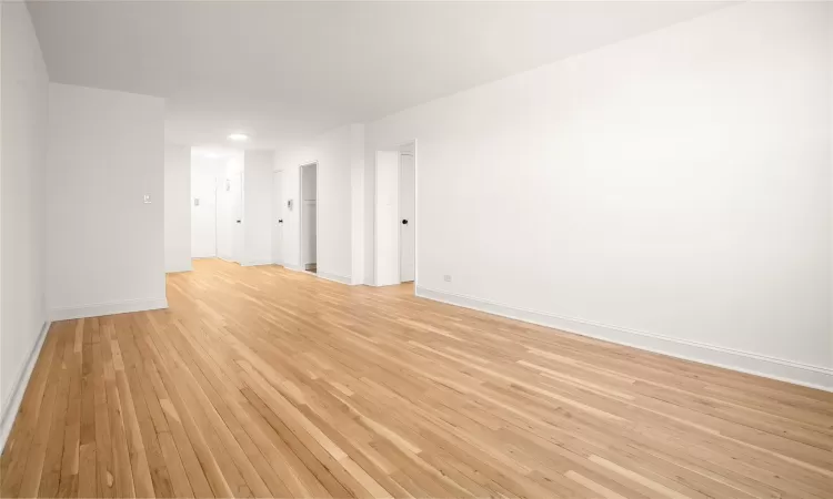 Living room facing entry with dining area