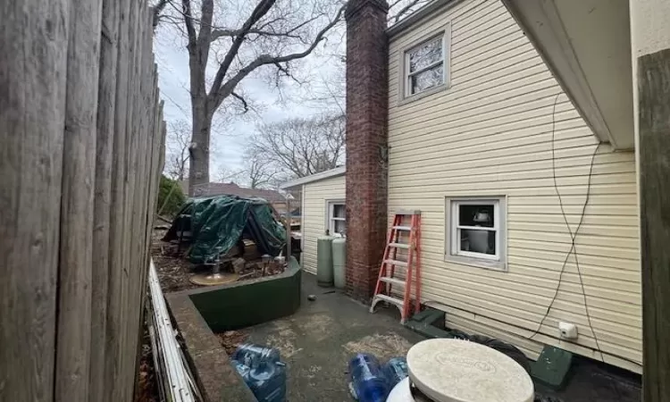 View of side of property with a chimney