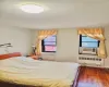 Bedroom featuring cooling unit, radiator, and dark wood-style flooring