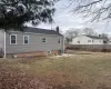 Back of property with a yard, cooling unit, fence, and a chimney