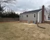 Back of property featuring a chimney, fence, cooling unit, and a yard