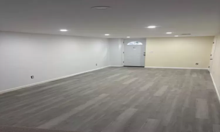 Finished basement with baseboards, wood finished floors, and recessed lighting