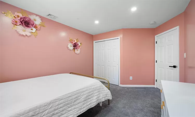 Carpeted bedroom featuring a closet, recessed lighting, visible vents, and baseboards