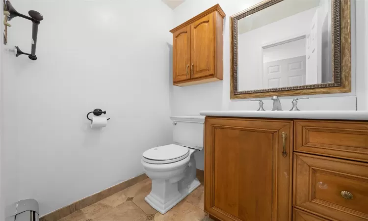 Half bath featuring vanity and toilet