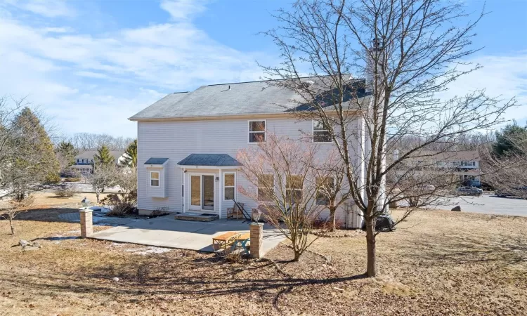 Rear view of property featuring entry steps and a patio