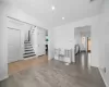 Foyer featuring stairway, recessed lighting, a lit fireplace, and wood finished floors