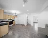 Kitchen with a baseboard radiator, under cabinet range hood, visible vents, freestanding refrigerator, and electric range oven