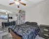 Bedroom featuring ceiling fan, a closet, and wood finished floors