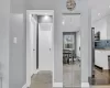 Hallway featuring baseboards, wood finished floors, and recessed lighting