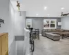 Living area featuring light wood finished floors, recessed lighting, baseboards, and a wall mounted air conditioner