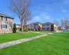 View of home's community with a residential view and a lawn