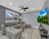 Living area with light wood-style floors, recessed lighting, baseboards, and a ceiling fan