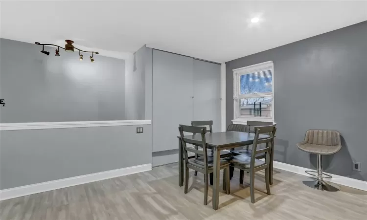 Dining space with light wood finished floors and baseboards