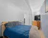 Bedroom featuring a textured ceiling, baseboards, and tile patterned floors