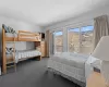 Carpeted bedroom with access to exterior, a mountain view, and a textured ceiling