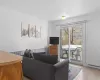 Living room with ornamental molding, baseboard heating, and light tile patterned floors