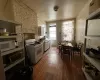 Kitchen with white appliances, washer / clothes dryer, and wood finished floors