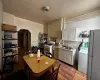 Kitchen featuring white appliances, arched walkways, washer / clothes dryer, light wood-type flooring, and a sink