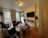 Living area featuring wood finished floors and radiator