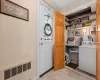 Laundry room featuring laundry area, washer / clothes dryer, and radiator heating unit