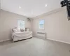 Bedroom featuring radiator heating unit, baseboards, carpet flooring, and a wall mounted air conditioner