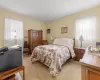 Bedroom with light carpet and a wall mounted air conditioner