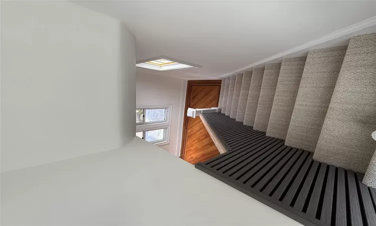 Unfurnished living room with wood-type flooring, baseboards, and a stone fireplace